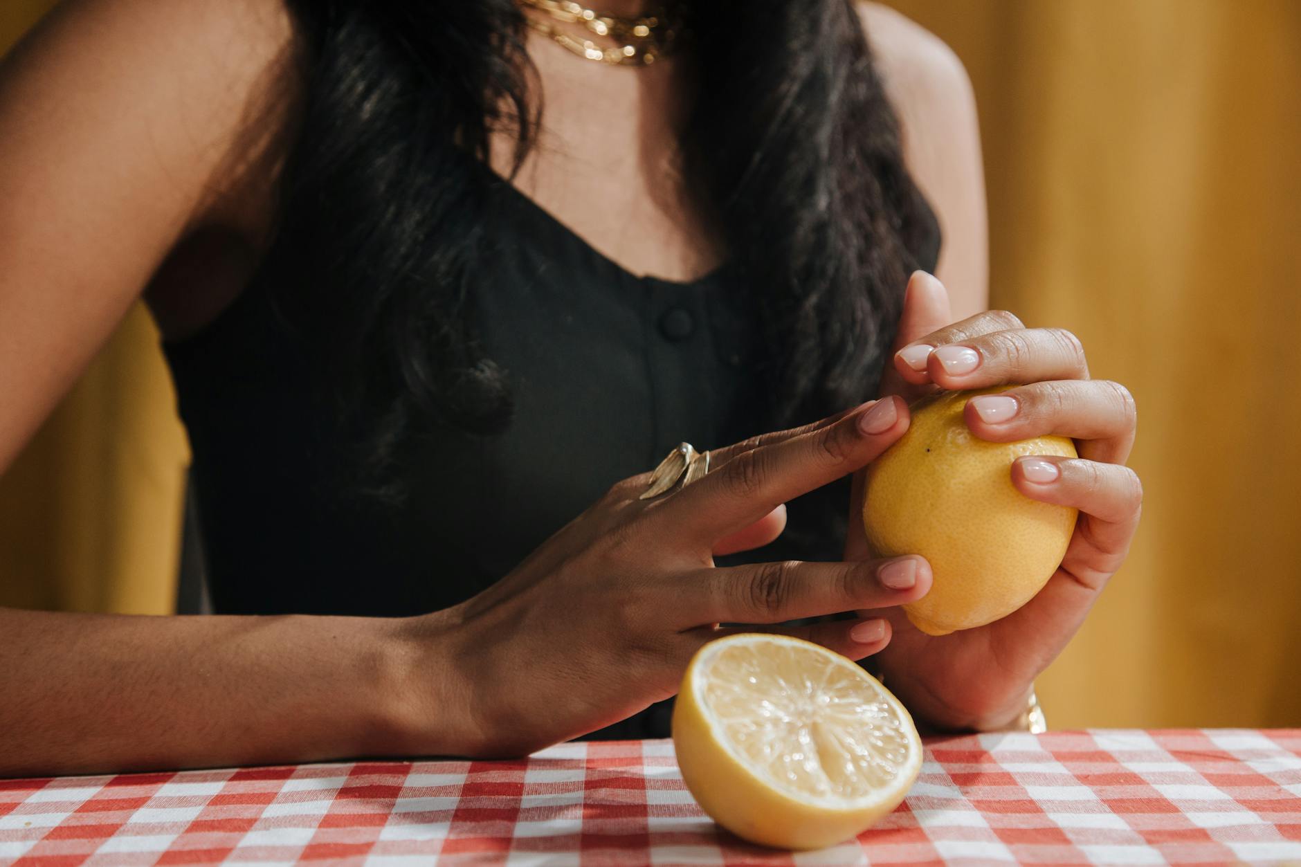 Hands cupped together holding fresh lemons, symbolizing self-care and personal renewal
