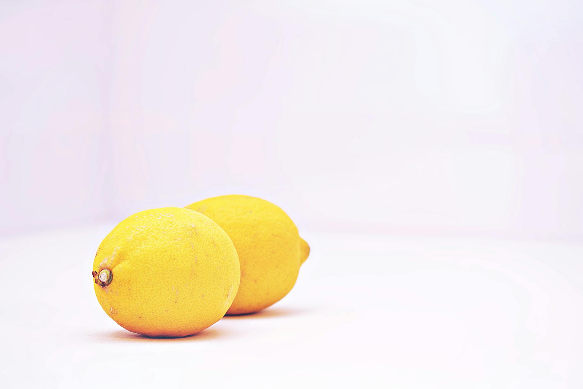 Bright yellow lemons on a white background representing freshness and renewal