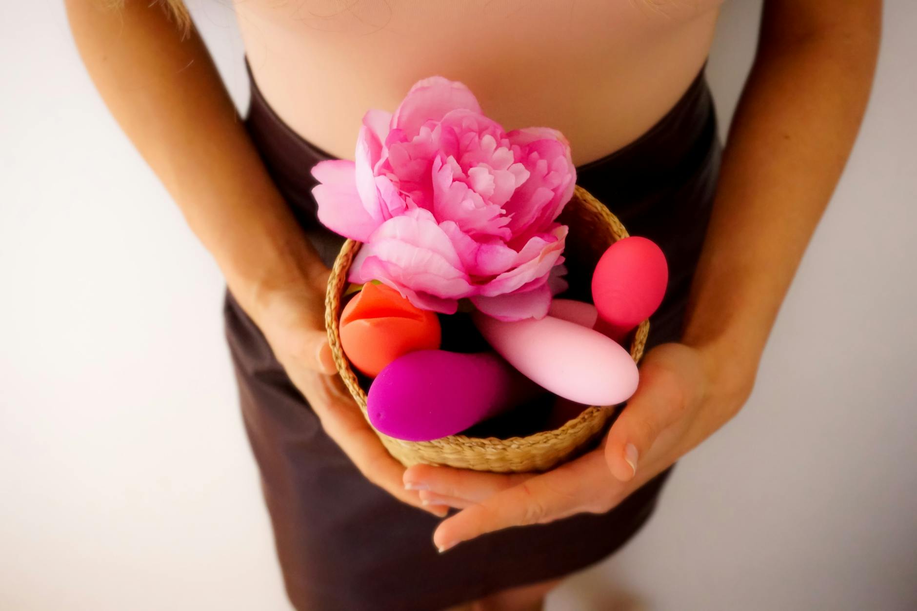 Vibrant collection of colorful vibrators arranged on a bright yellow surface